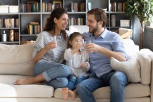 family drinking from a glass of water