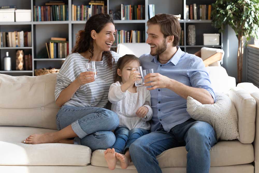 family drinking from a glass of water